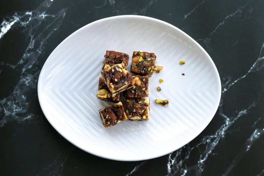 Image of a plate of snacks that blend together dates and various types of nuts.