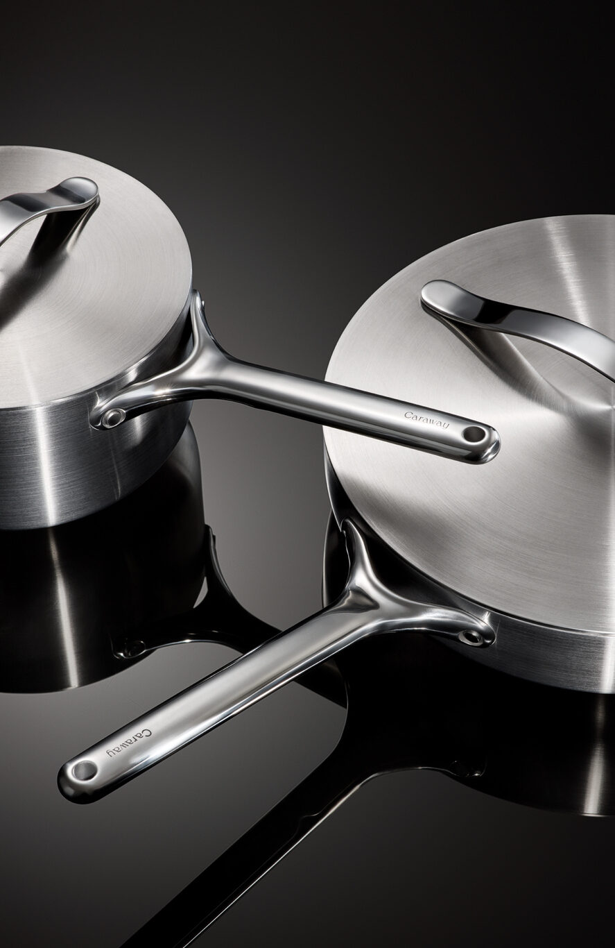 Image of a Caraway Stainless Steel sauce pan and sauté pan with a focus on the details on the handles.
