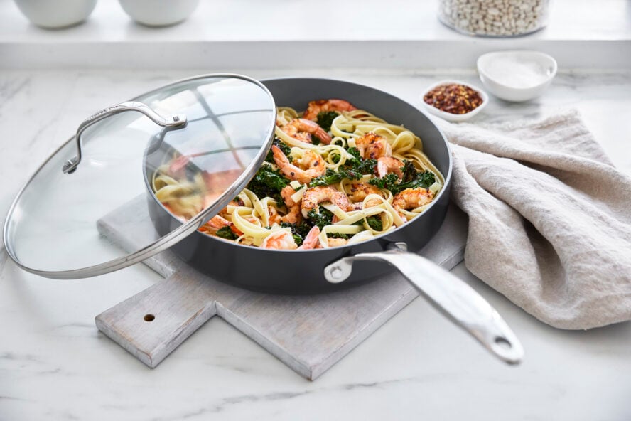 Image of a GreenPan Valencia Pro sauté pan with a giant lid, with a creamy prawn pasta.