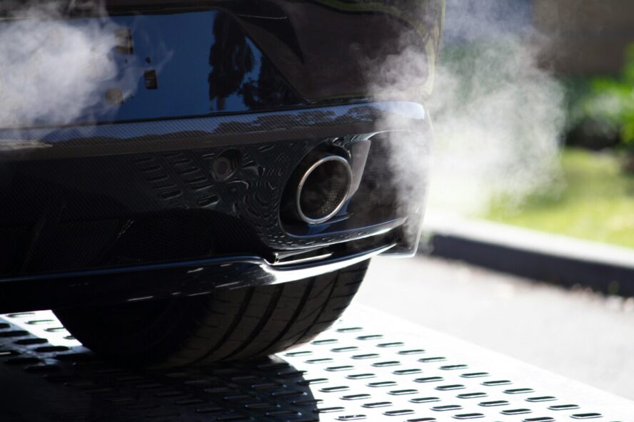 Image of a tailpipe emissions being released from a car.