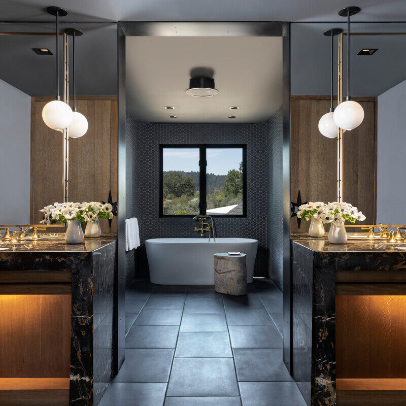 Image of the bathroom in one of the residences at the Four Seasons Resort in Napa Valley, with wood accents and warm lighting.
