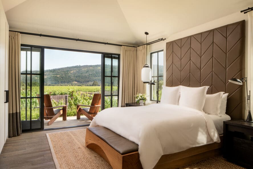 Image of a bedroom in one of the Four Seasons Napa Valley residences, overlooking the vineyards.