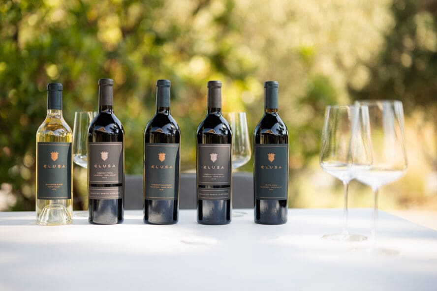 Image of a row of five bottles of wine from Elusa Winery, the onsite winery at the Four Seasons Napa Valley.