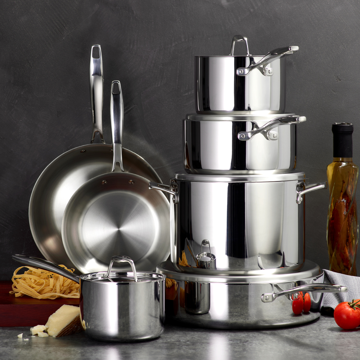 Image of the Tramontina 12-piece stainless steel cookware set nested and stacked on a grey countertop.