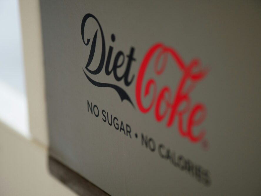 Image of the side of a grey case of Diet Coke shot from an angle.
