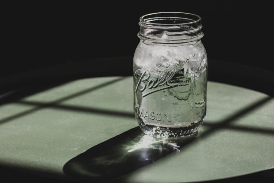 Image of a glass mason jar filled with tap water and ice.