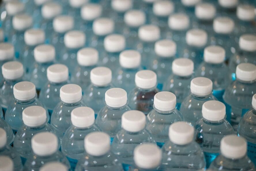 Image of dozens of plastic water bottles shown from above.