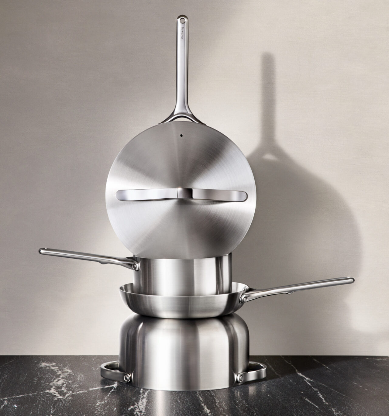 Image of several Caraway stainless steel cookware pieces stacked on top of each other.