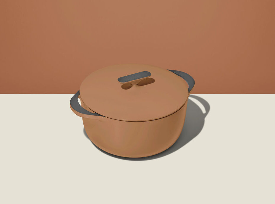 Image of the Caraway Enameled Cast Iron Dutch Oven in Rust, set against a matching background.