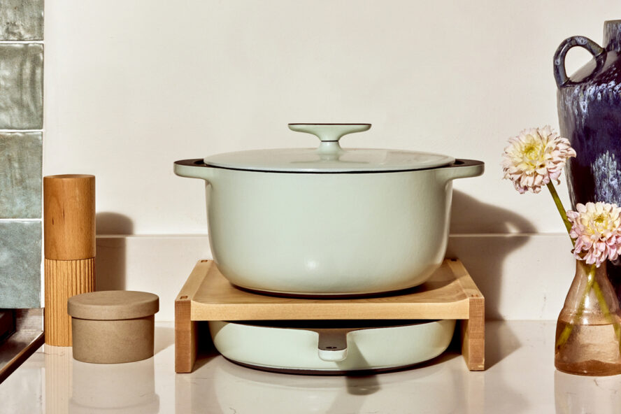 Image of a Caraway Round Dutch Oven in a gorgeous pale green color set in a modern kitchen.