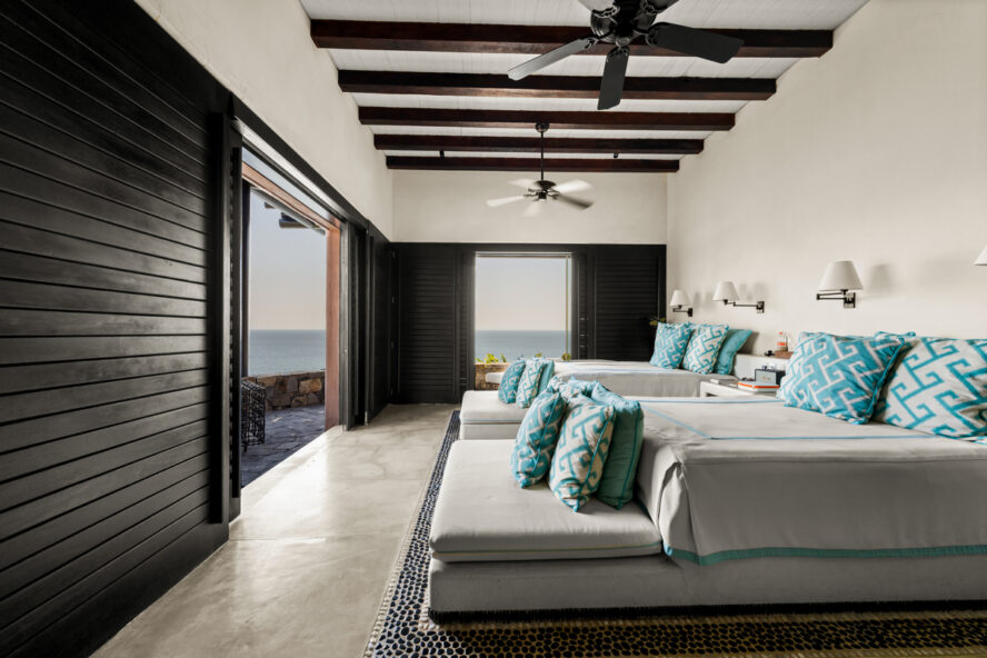 Image of a room at ZihFit, featuring two double beds facing a beautiful view.