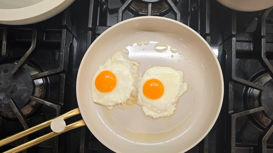 Our Place Essentials frypan with perfectly cooked eggs that are going to slide right out.