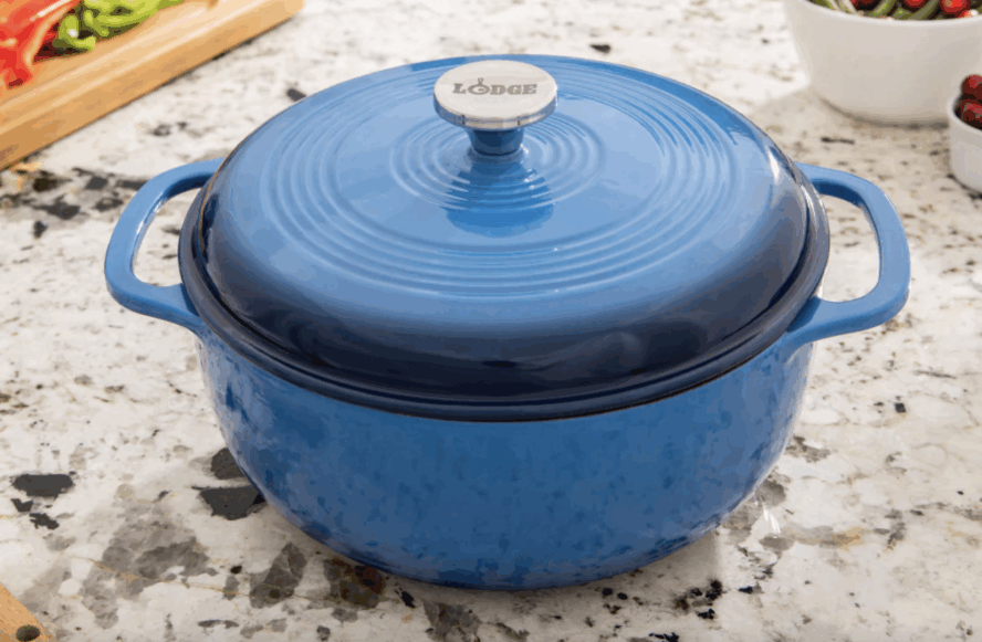 Image of the Lodge Essential Enamel Cast Iron Dutch Oven in blue, displayed on a marble countertop.