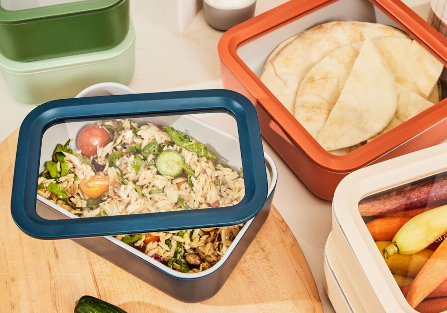 Image of several Caraway Food Storage Containers in warm colors, being used to store leftovers.