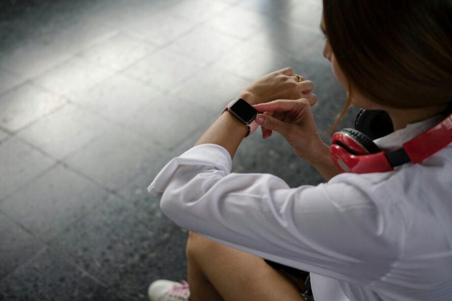 Image of a woman looking at the time on her watch on her left wrist.