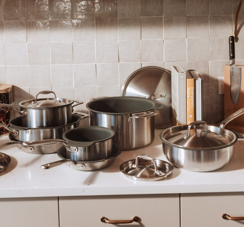 Image of Made In Stainless Steel Cookware set shown against a white tile backdrop.