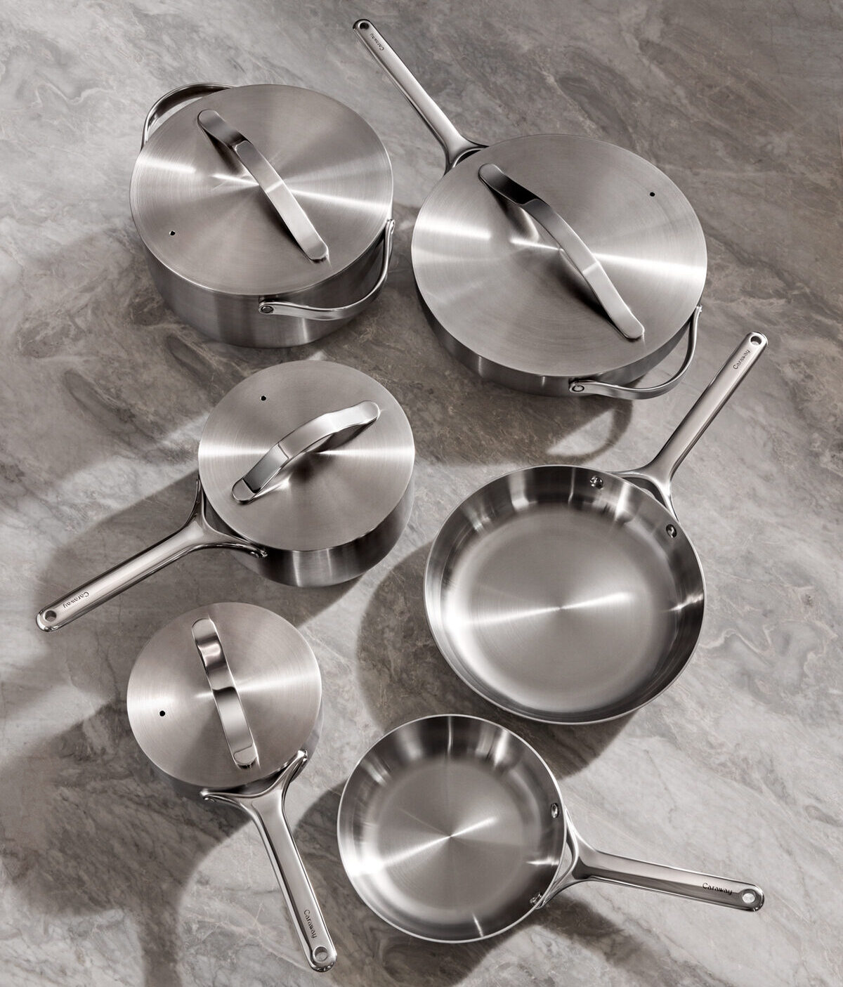 Image of several pieces in the Caraway Stainless Steel cookware set shot from above.