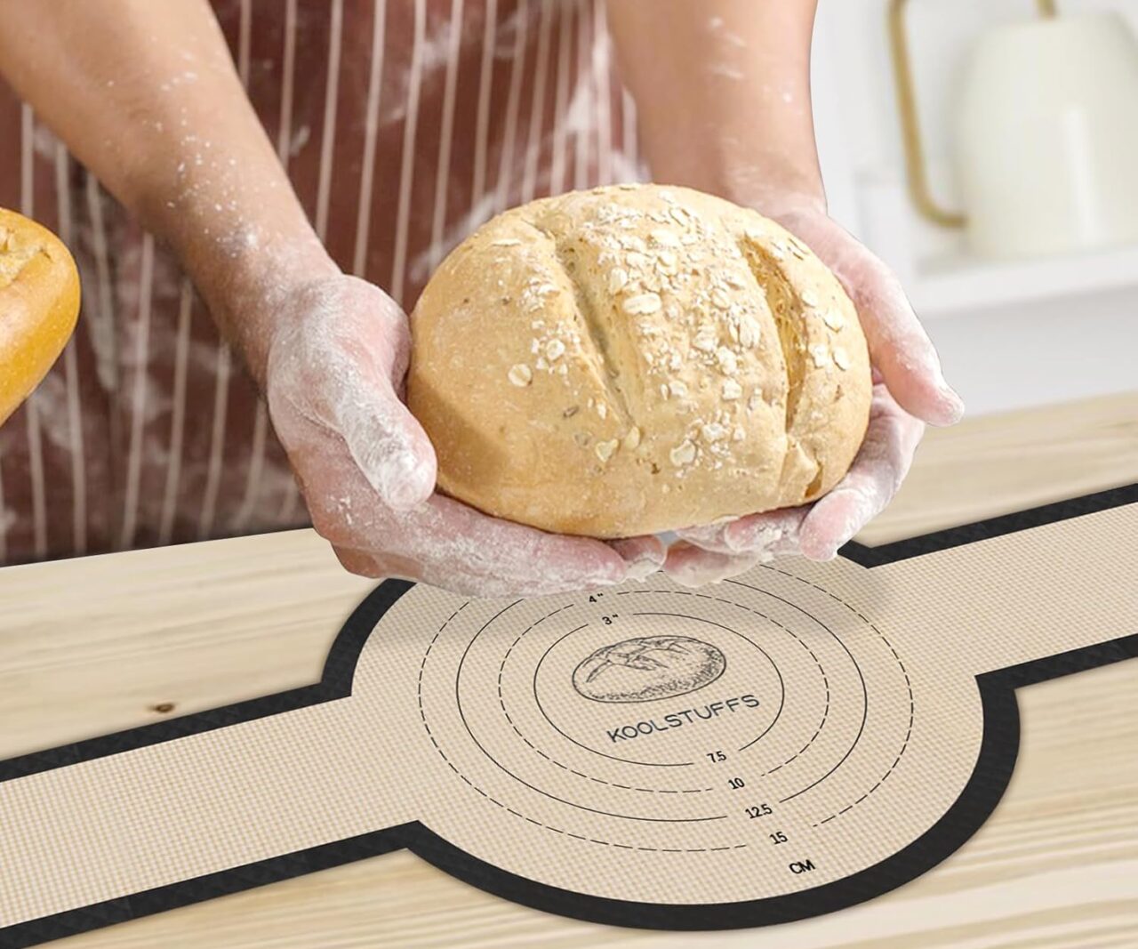 Image of the silicone bread sling shown underneath bread dough shaped into a loaf.