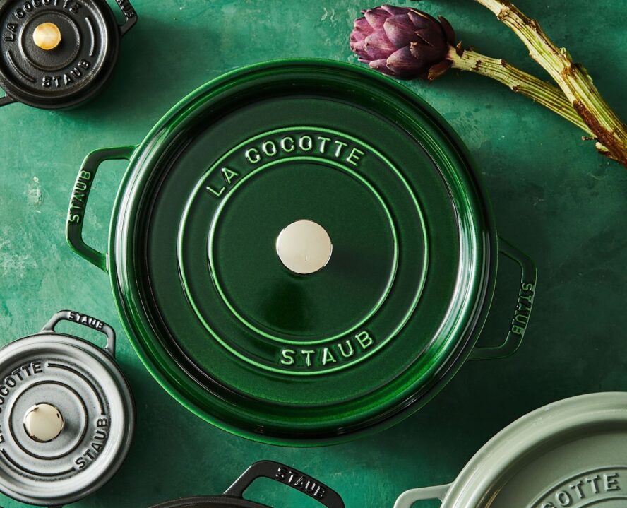 Image of a Staub Dutch oven in the color Basil, set against a similar green background.