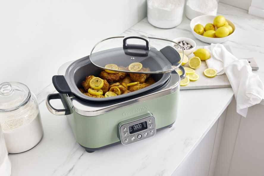 Image of the GreenPan Elite Slow Cooker in Sage Green, filled with chicken and lemons.