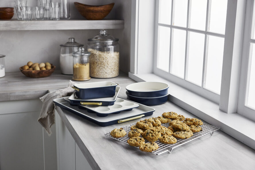 Image of a tray of cookies and several pieces of GreenPan Reserve Bakeware in Oxford Blue stacked behind it.