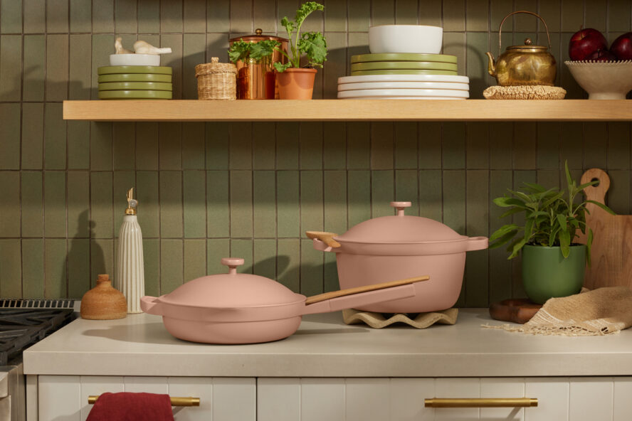 Image of the Our Place Cookware Duo in the color Spice, set in a beautiful kitchen with the Perfect Pot resting on an Our Place Trivet.