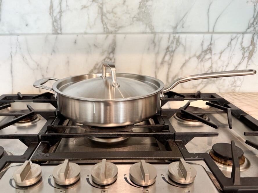 Image of the Made In CeramiClad 3.5-quart sauté pan with lid on a stovetop.