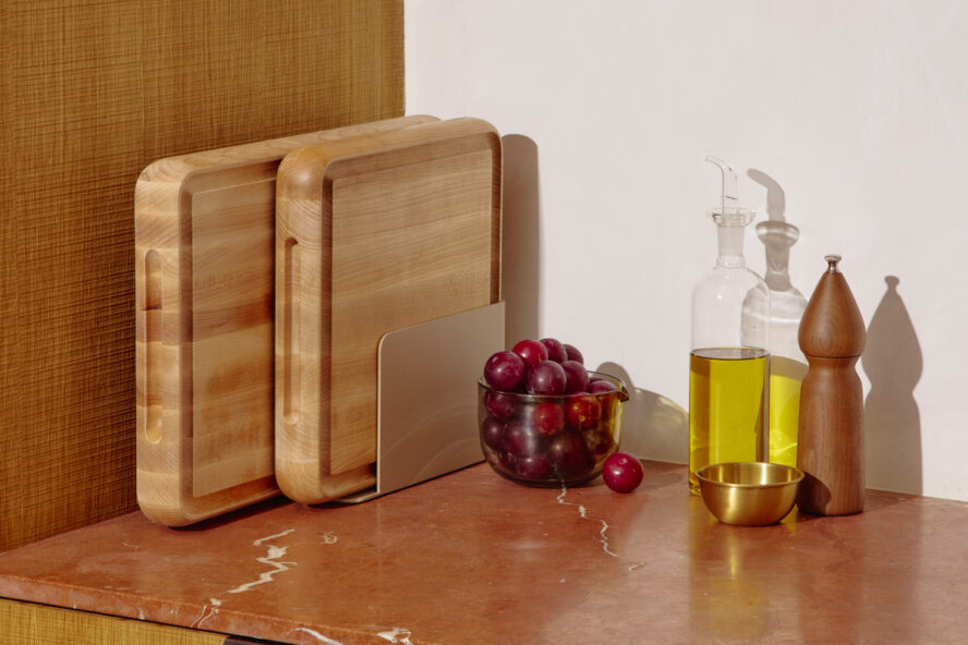 Image of the Caraway Dual-Sided Prep & Serve Butcher Block Set in maple, displayed in the included organizer.