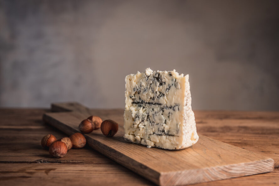 Image of a gorgeous wedge of Smokey Blue cheese from Rogue Creamery, Oregon.