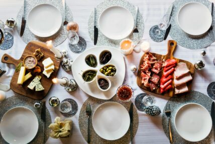 Image of a beautiful table set with a cheese board and olive bar