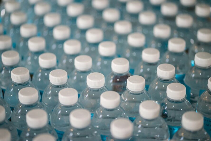 Image of dozens of plastic water bottles shot from above.