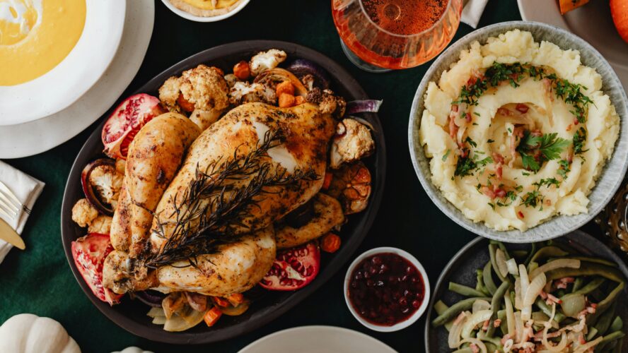 image of a whole turkey on a Thanksgiving table. What are the pros and cons of brining turkey?