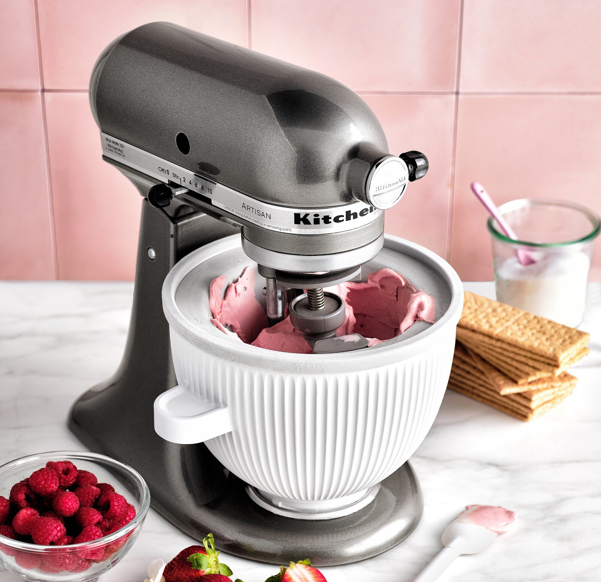 Image of a KitchenAid® Artisan Stand Mixer in contour silver being used to whip up a pink raspberry frosting.