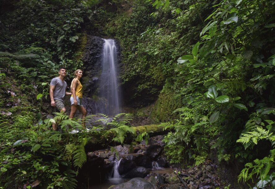 Image of a couple climbing at the private waterfall at Origin Floral Luxury Lodge.