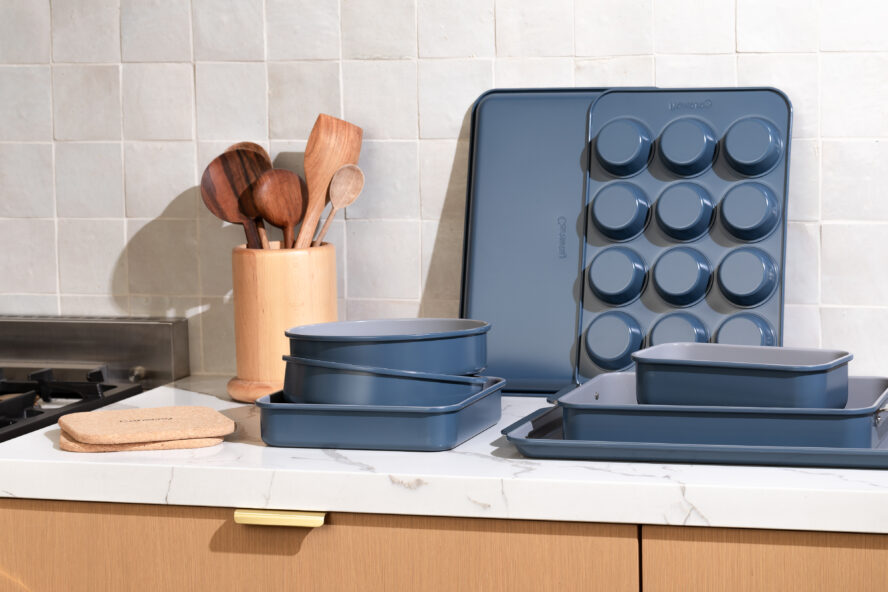 Caraway cookware stacked neatly on a countertop to show of the versatility of this complete set