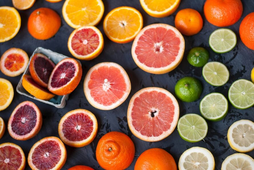 Image of dozens of slices of grapefruit, oranges, and citrus fruit against a black background.