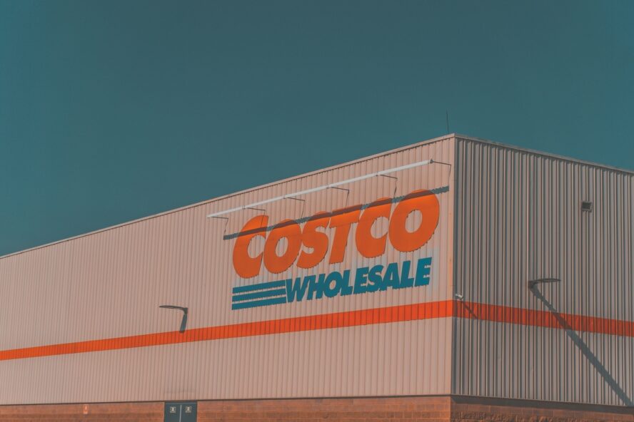 Image of a giant warehouse with large signage reading "Costco Wholesale".