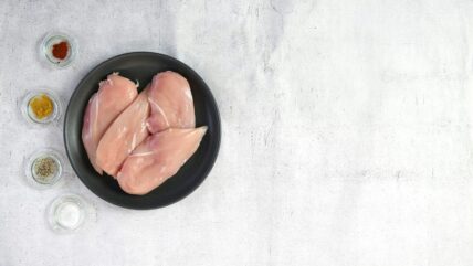 image of raw chicken on a plate next to dried seasoning salmonella in costco chicken philippe zuber unsplash