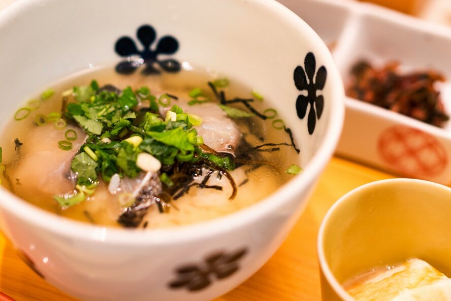 Image of a small bowl of miso soup, topped with fresh green onions.