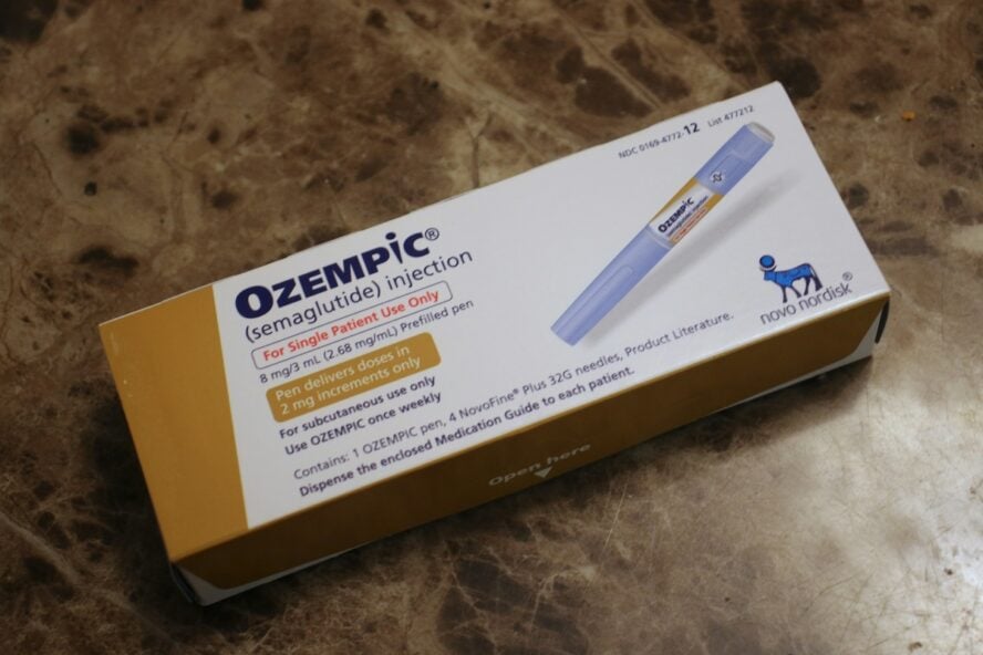 Image of a box of infamous GLP-1 medication Ozempic, with a photo of a pen injector on the front of the box.