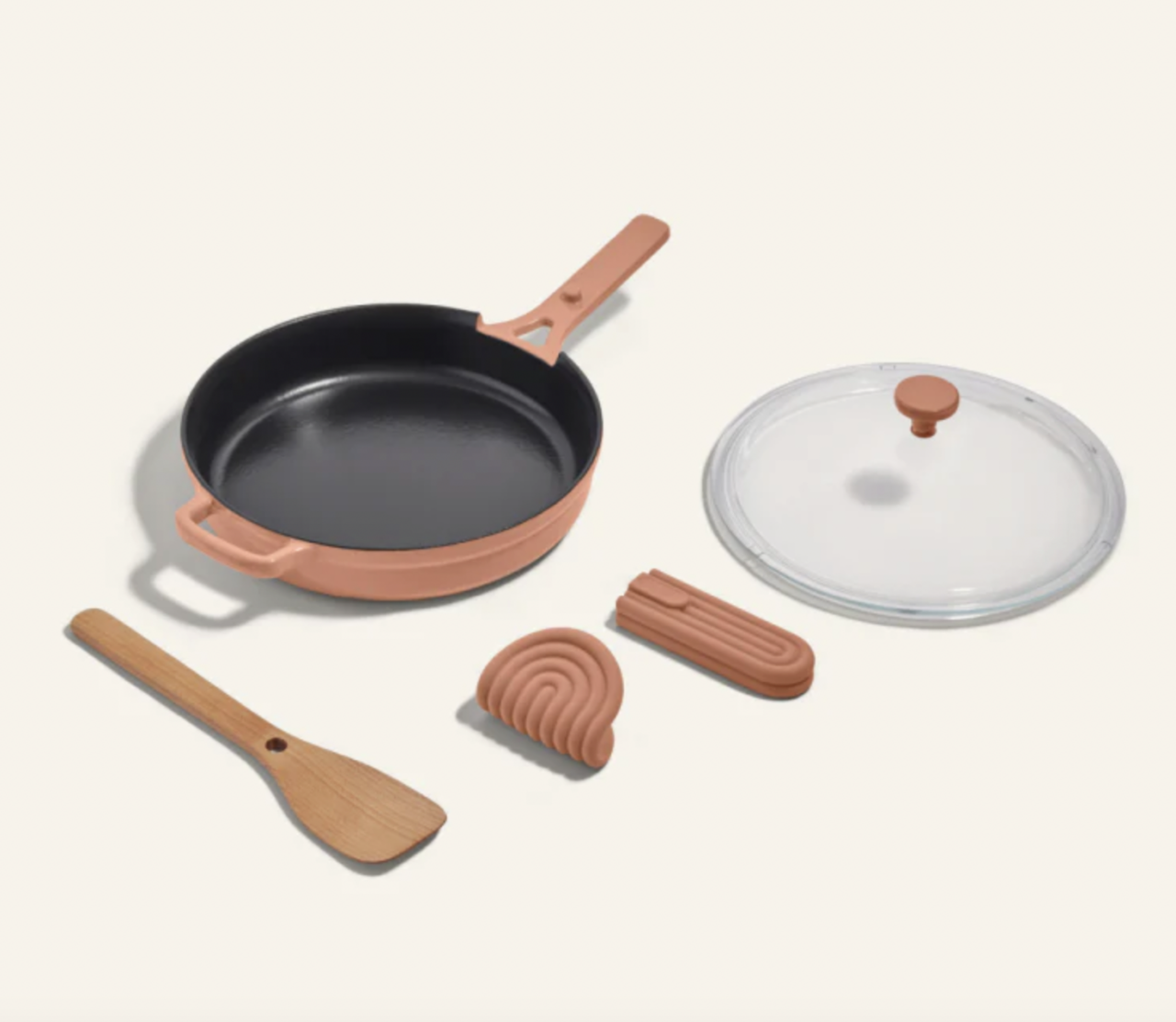 Image of the Cast Iron Always Pan in Spice, shown with the included items such as the lid, nesting spatula, and hot grips.
