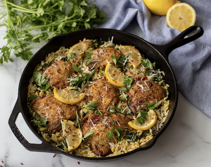 Image of the Lodge 12-inch Seasoned Cast Iron Skillet filled with lemony chicken thighs.