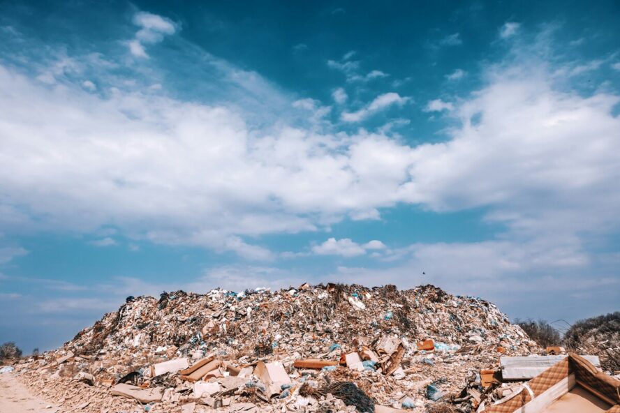 Image of a giant pile of plastic, set against a blue sky.