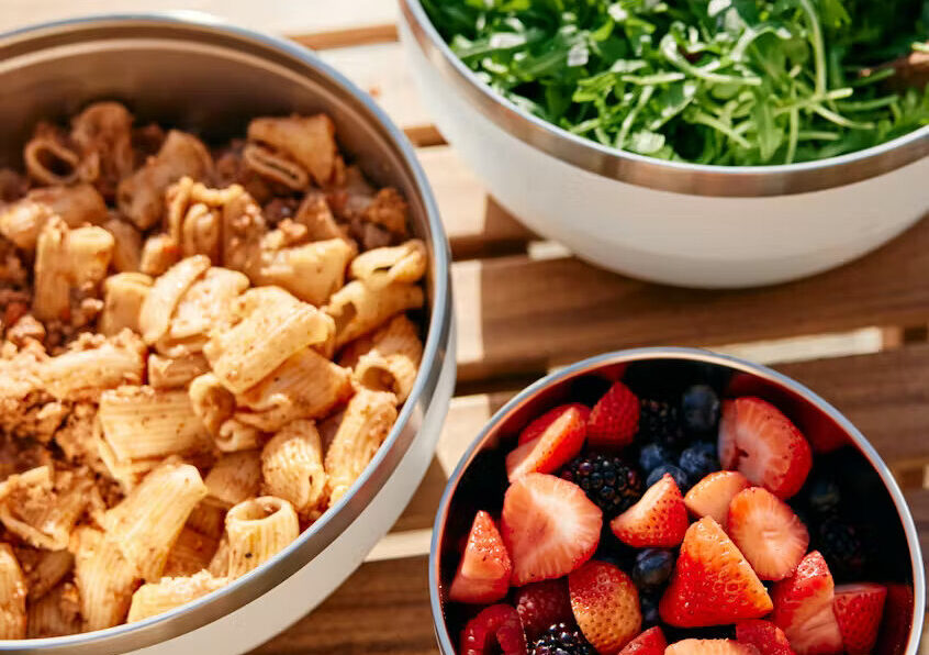 Image of three YETI Food Insulated Bowls filled with various snacks, including berries and salad.