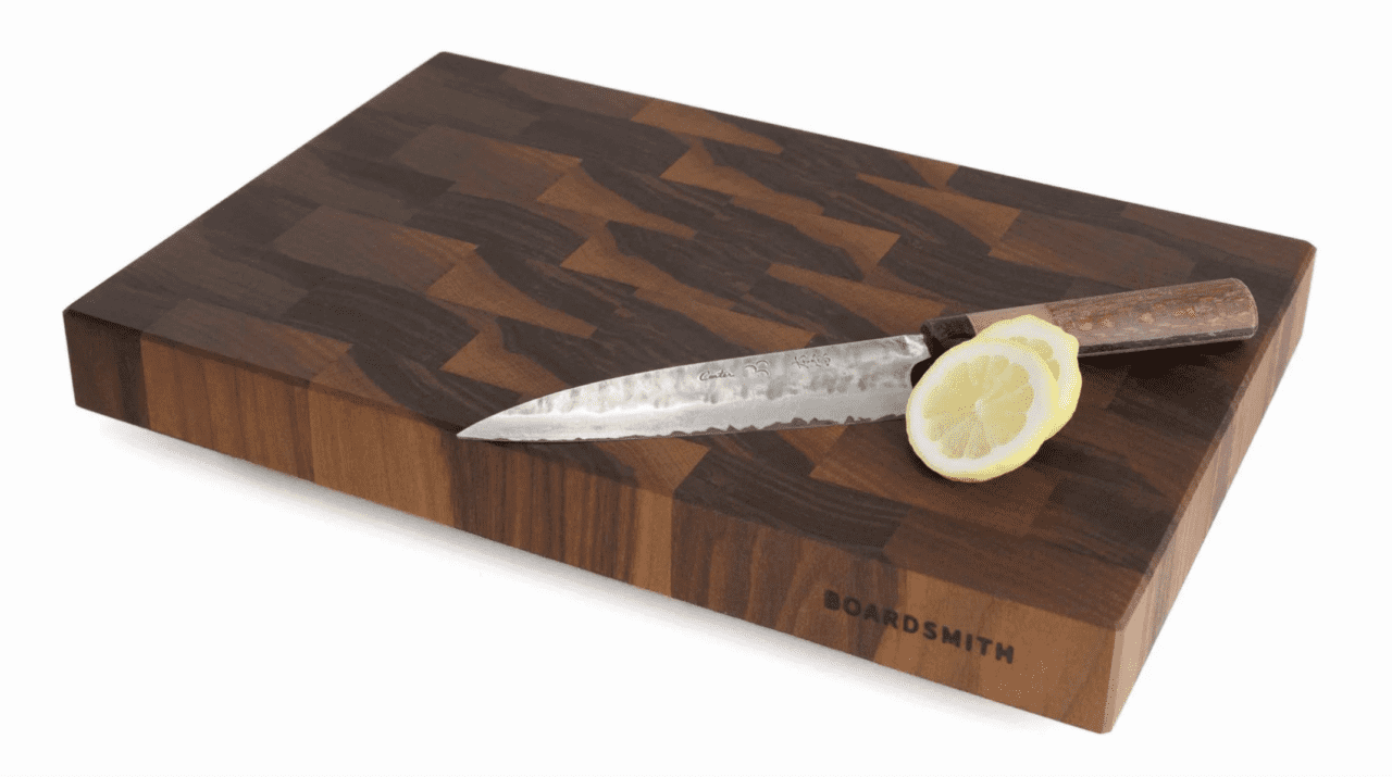 Image of a Boardsmith Walnut End-Grain Cutting Board shown with a knife and lemon slices.