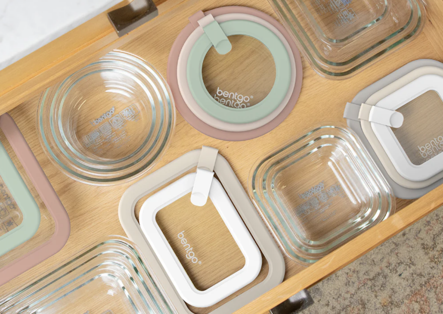Image of a drawer in a kitchen filled with containers and lids from a Bentgo set.