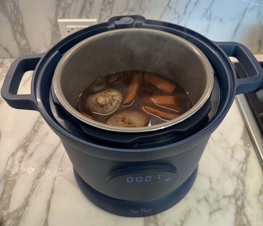 Image of the Our Place Dream Cooker in Blue Salt, shown with a soup inside.