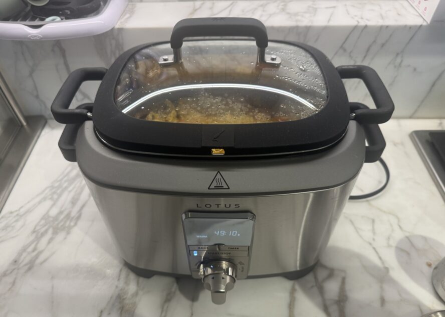 Image of the Lotus The Sous Multi-Function Slow Cooker on a marble countertop.