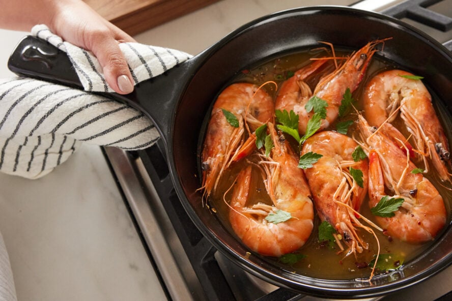 Image of a large Xtrema pure ceramic skillet being used to cook tiger prawns.