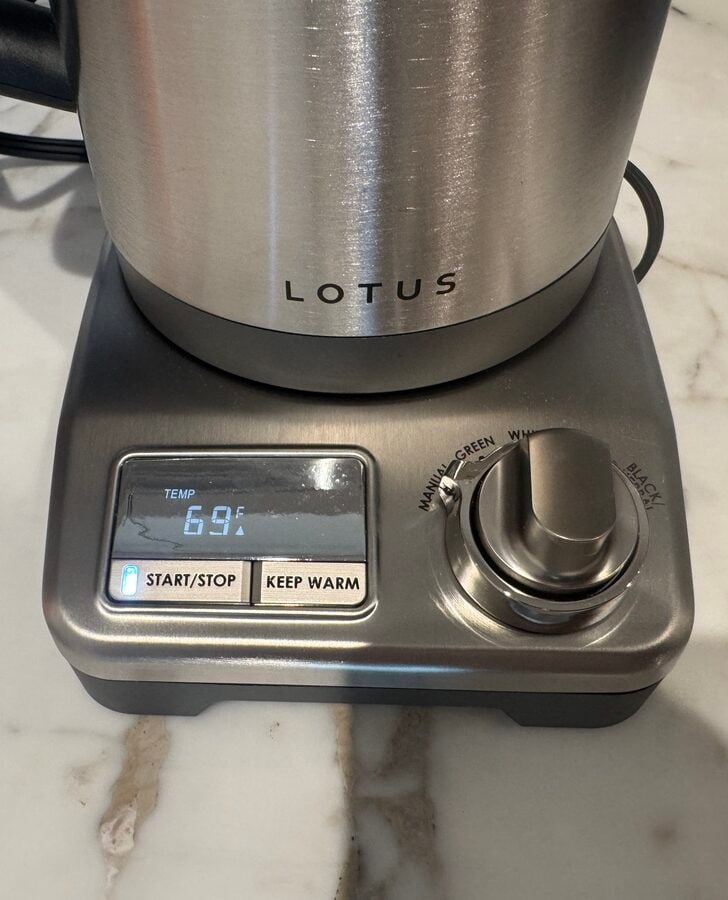 Close-up image of the base of the Lotus The Purist Precision Temperature Kettle, showing the dial and digital display.